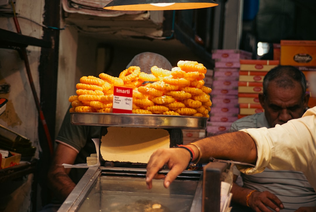 Sweet fried dough rings stacked at a market stall